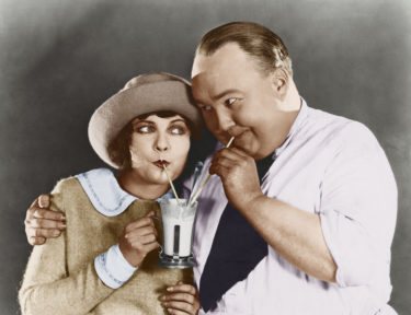 Couple sharing beverage with straw