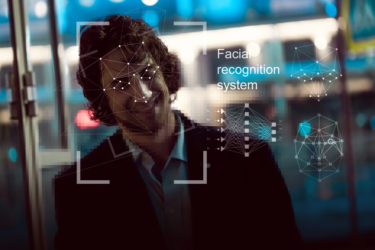 Facial recognition system, concept. Young man on the street face recognition