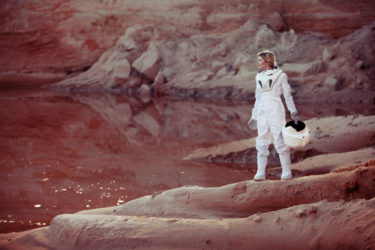 futuristic astronaut on another planet, sandy red planet